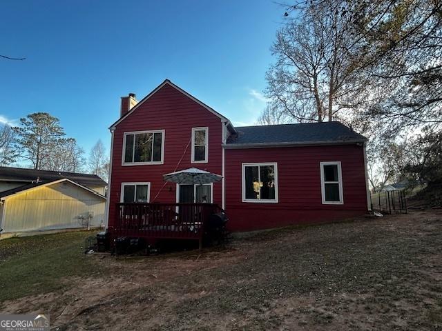 back of property featuring a deck