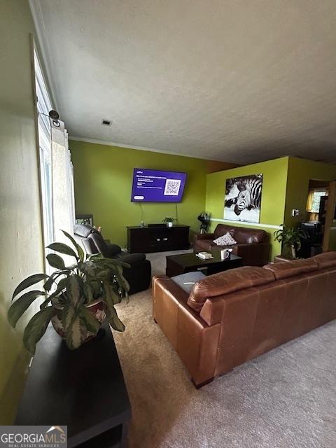 living room with carpet flooring and ornamental molding