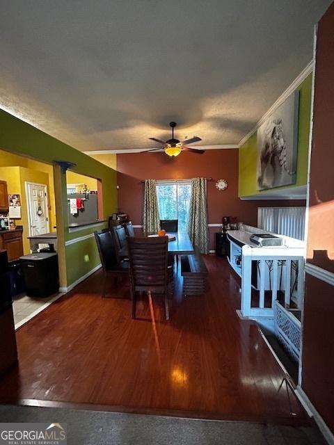 dining area with hardwood / wood-style floors, ceiling fan, and ornamental molding