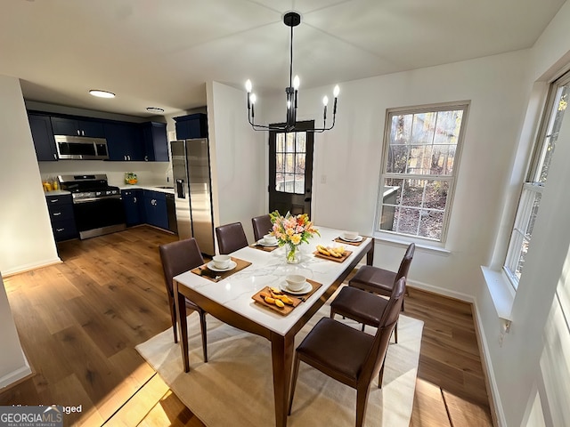 dining area featuring a chandelier and light wood-type flooring