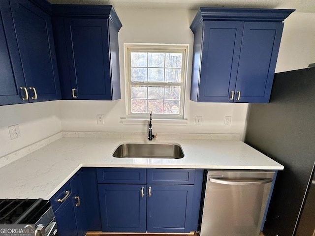 kitchen with stainless steel dishwasher, blue cabinets, and sink