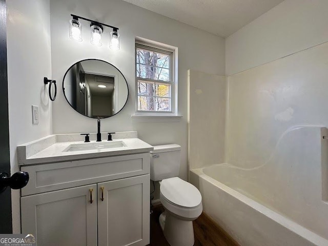 full bathroom featuring shower / washtub combination, vanity, and toilet