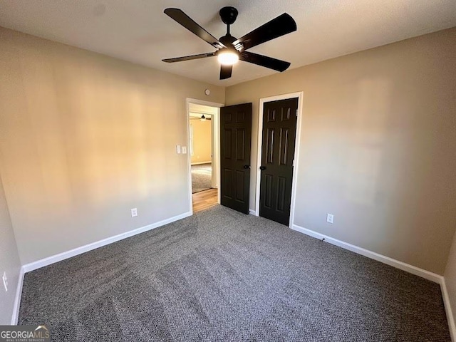 unfurnished bedroom featuring carpet and ceiling fan