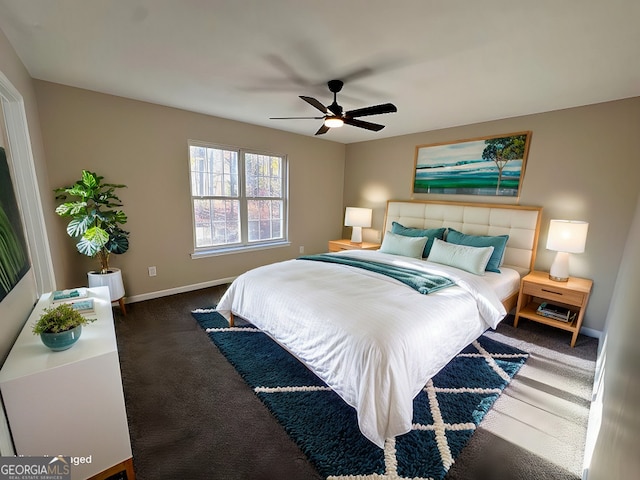 bedroom with dark colored carpet and ceiling fan