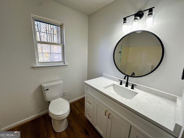 bathroom with hardwood / wood-style floors, vanity, and toilet