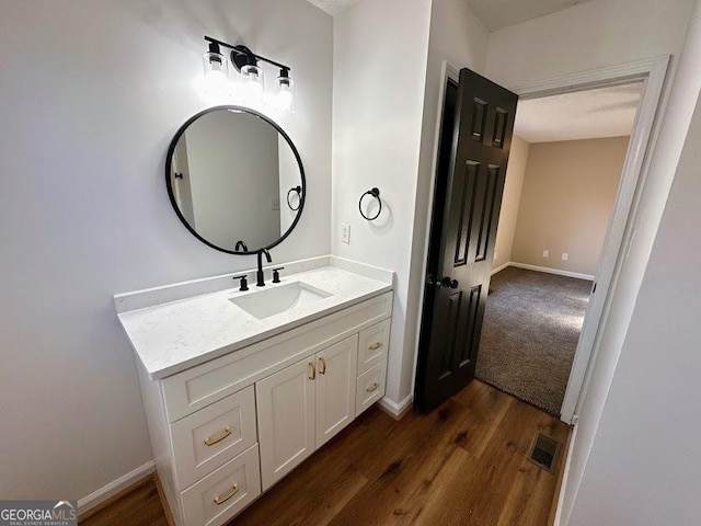 bathroom featuring vanity and hardwood / wood-style flooring