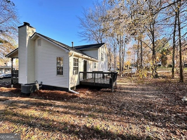 view of property exterior with a deck and cooling unit