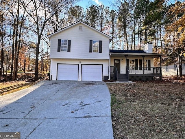 tri-level home with covered porch and a garage