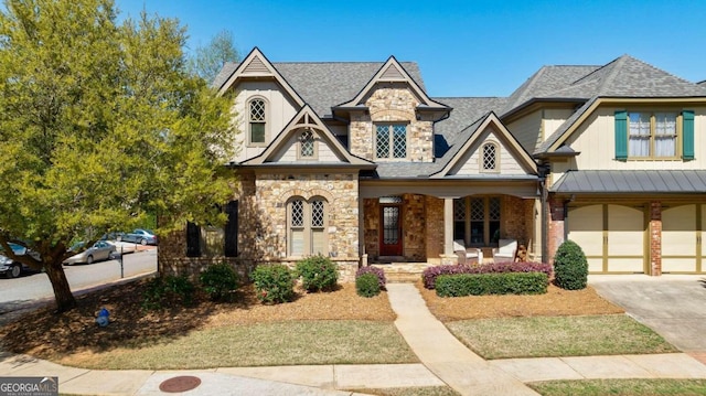 view of front of home featuring covered porch and a garage