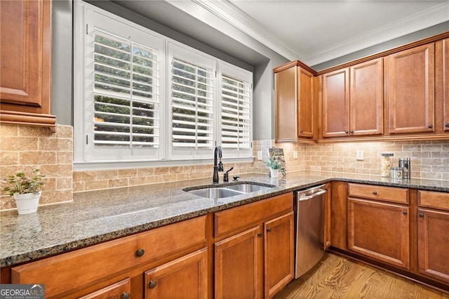 kitchen featuring light wood-type flooring, crown molding, sink, stone counters, and dishwasher