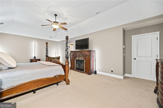 bedroom featuring ceiling fan, light carpet, and vaulted ceiling