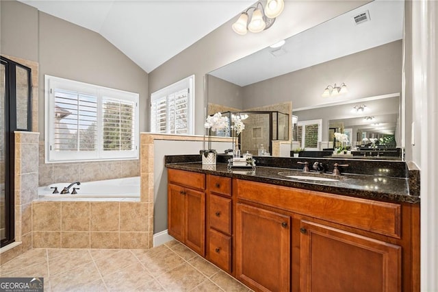 bathroom with tile patterned floors, vanity, vaulted ceiling, and shower with separate bathtub