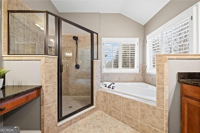 bathroom with tile patterned floors, vanity, independent shower and bath, and lofted ceiling