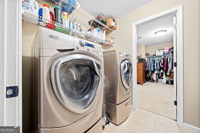 laundry room with washer and dryer and light carpet