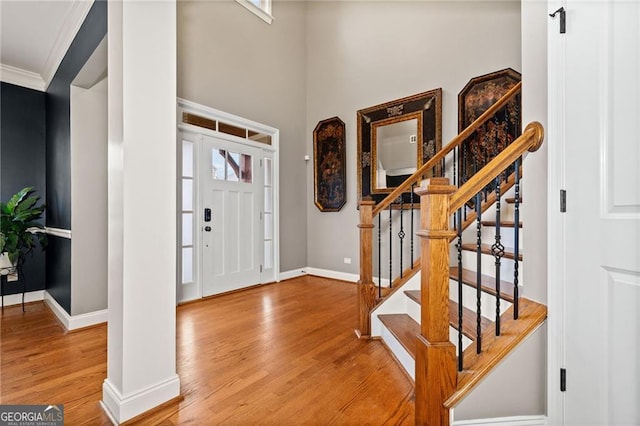 entrance foyer with wood-type flooring and ornamental molding