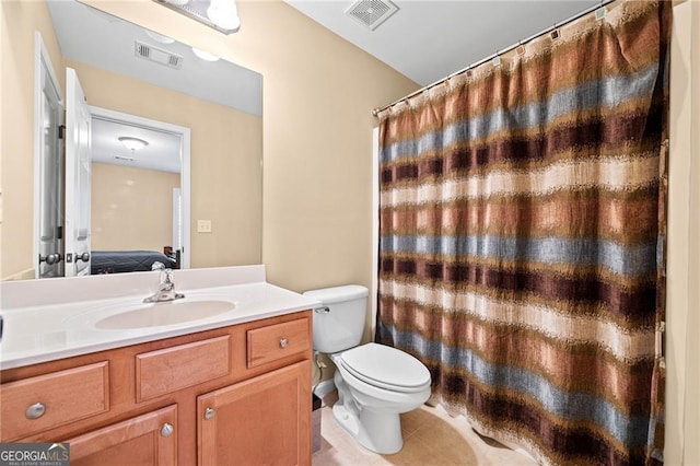 bathroom featuring toilet, a shower with curtain, vanity, and tile patterned floors