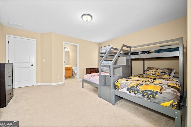 bedroom with carpet floors and connected bathroom