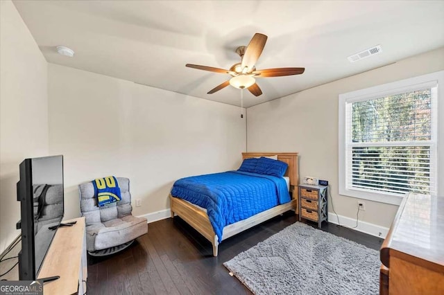 bedroom with dark hardwood / wood-style floors and ceiling fan