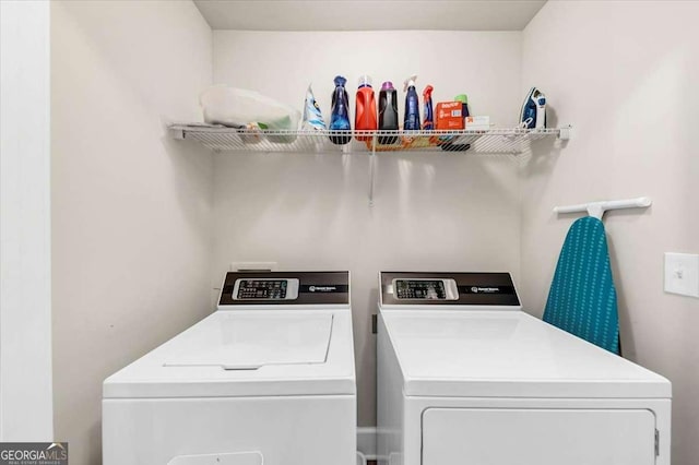 laundry room featuring washing machine and clothes dryer