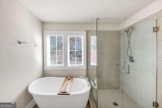 bathroom featuring separate shower and tub