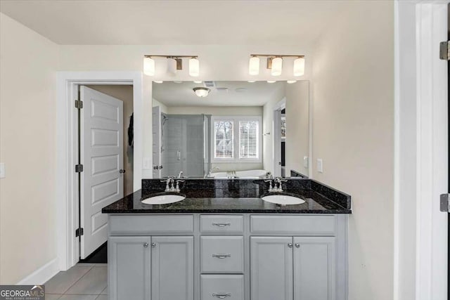 bathroom featuring tile patterned floors, vanity, and shower with separate bathtub