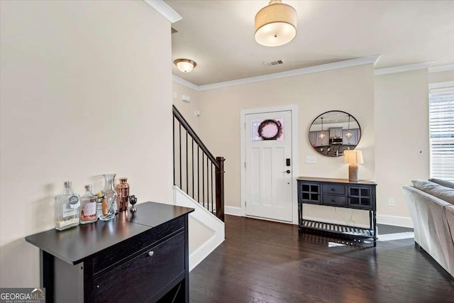 foyer featuring dark hardwood / wood-style flooring and crown molding