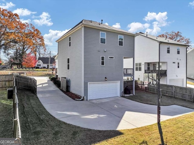 rear view of house featuring a garage