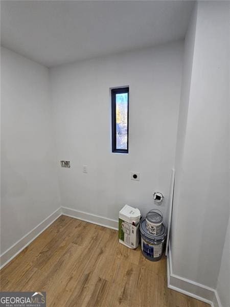 laundry room featuring electric dryer hookup and light hardwood / wood-style floors