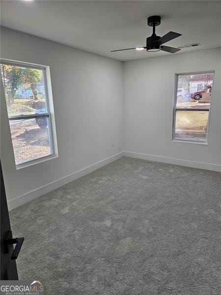 empty room featuring ceiling fan and carpet floors