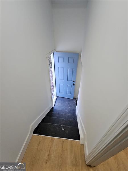 entryway with dark hardwood / wood-style flooring