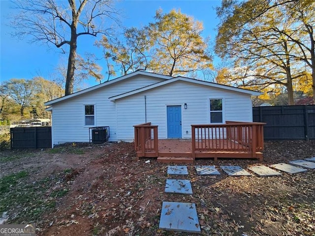 rear view of property with central air condition unit and a deck