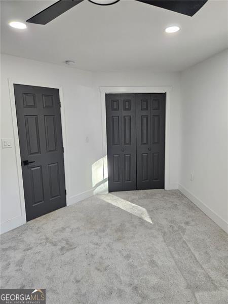 unfurnished bedroom with carpet and a closet