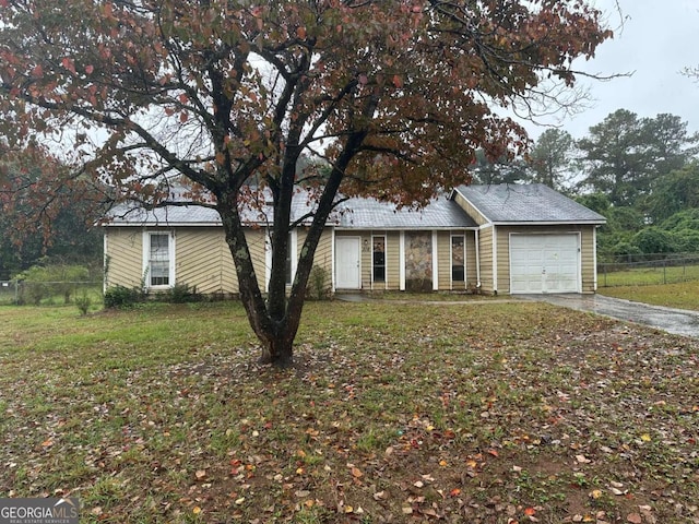 single story home featuring a garage and a front yard