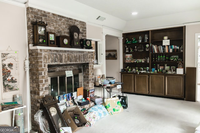 bar featuring a fireplace, dark brown cabinetry, and crown molding