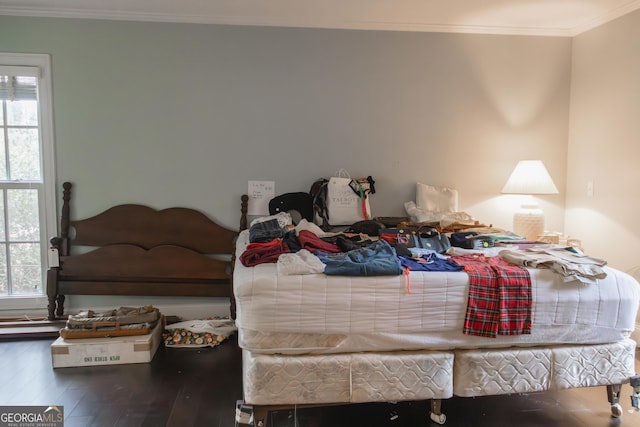 bedroom with hardwood / wood-style floors and ornamental molding