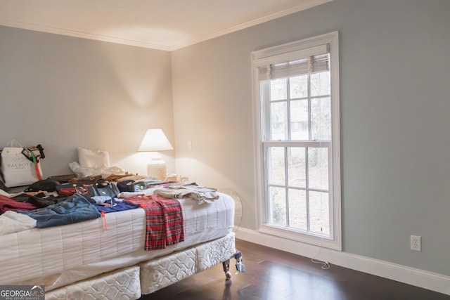 bedroom with dark hardwood / wood-style floors, ornamental molding, and multiple windows