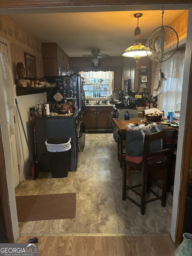 dining area featuring ceiling fan and sink