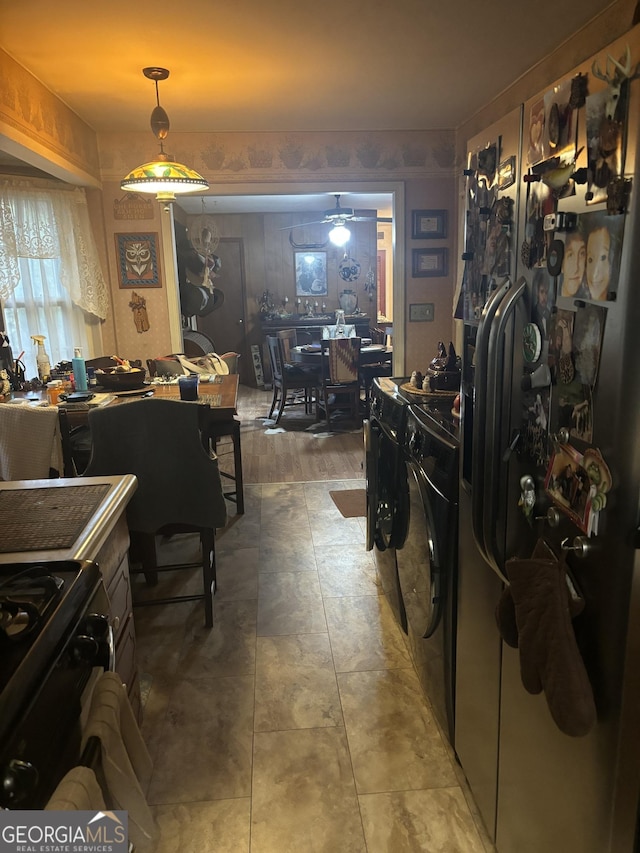 kitchen featuring washer / clothes dryer, ceiling fan, and black range oven