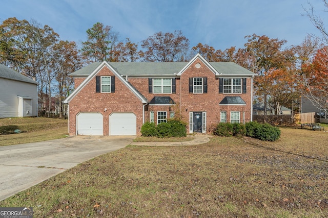 view of front of property featuring a front yard and a garage