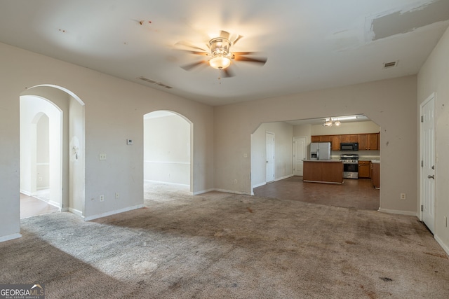 unfurnished living room with light carpet and ceiling fan