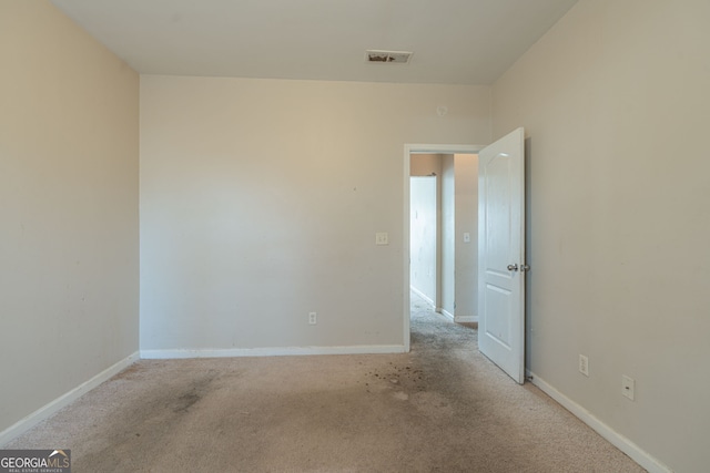 unfurnished room with light colored carpet