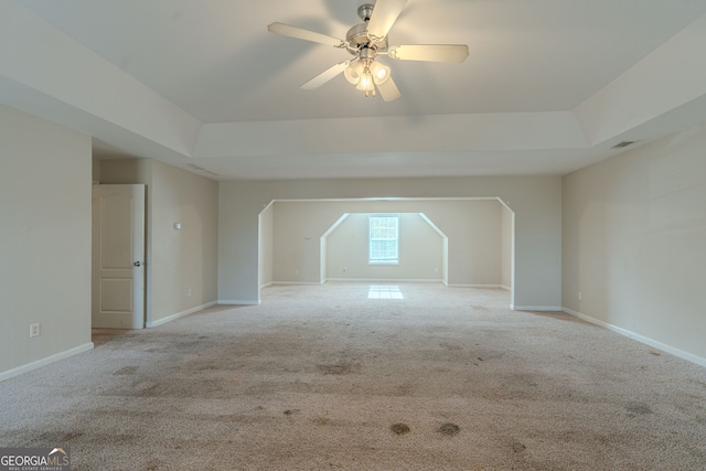 additional living space featuring light carpet and ceiling fan