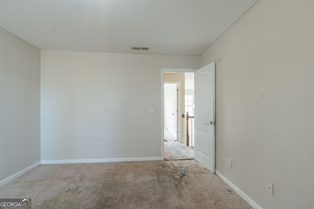 spare room featuring light colored carpet