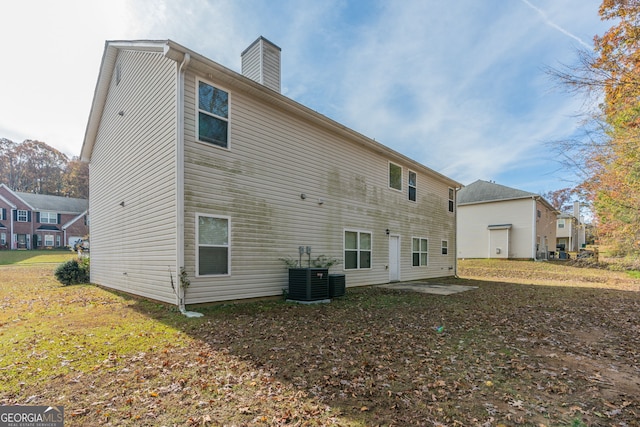 rear view of house featuring cooling unit and a patio