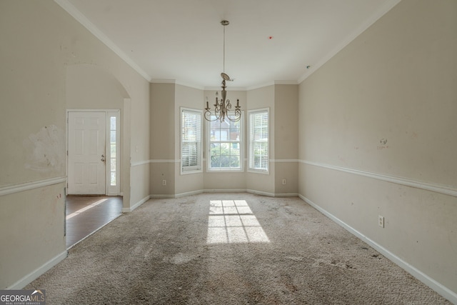 unfurnished dining area featuring a notable chandelier, ornamental molding, and light carpet