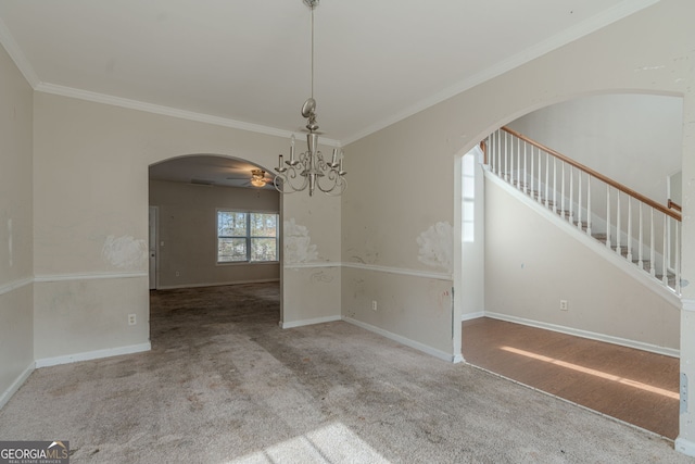 unfurnished dining area featuring carpet, ceiling fan with notable chandelier, and ornamental molding