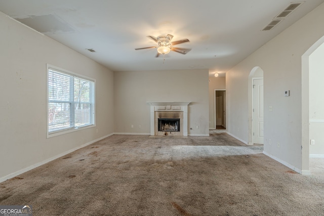 unfurnished living room featuring ceiling fan and light carpet