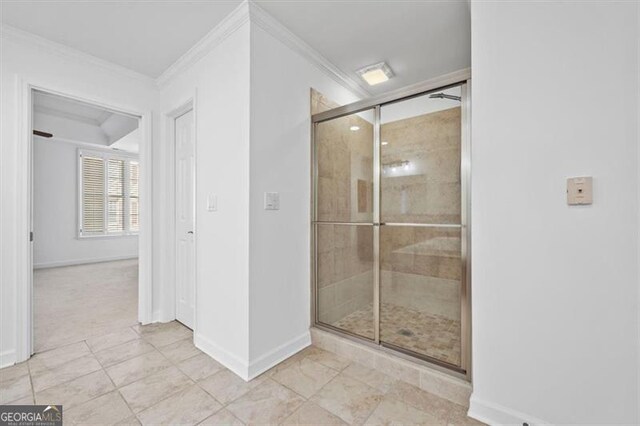 bathroom featuring tile patterned flooring, ornamental molding, and walk in shower