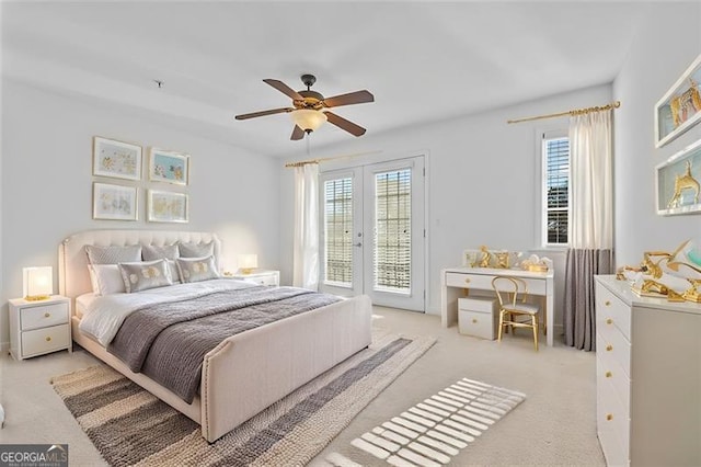 bedroom with access to outside, multiple windows, ceiling fan, and light carpet