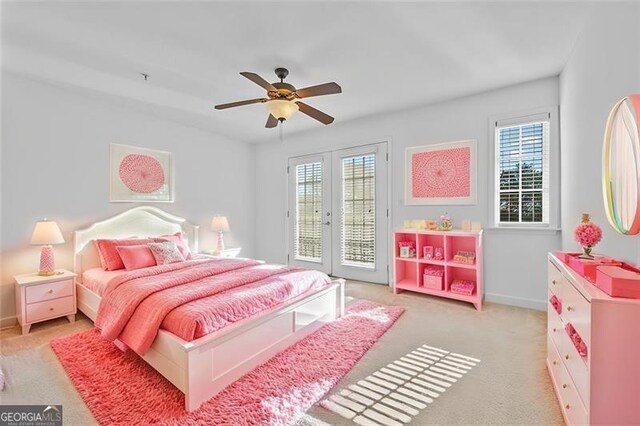 carpeted bedroom featuring access to outside, multiple windows, ceiling fan, and french doors